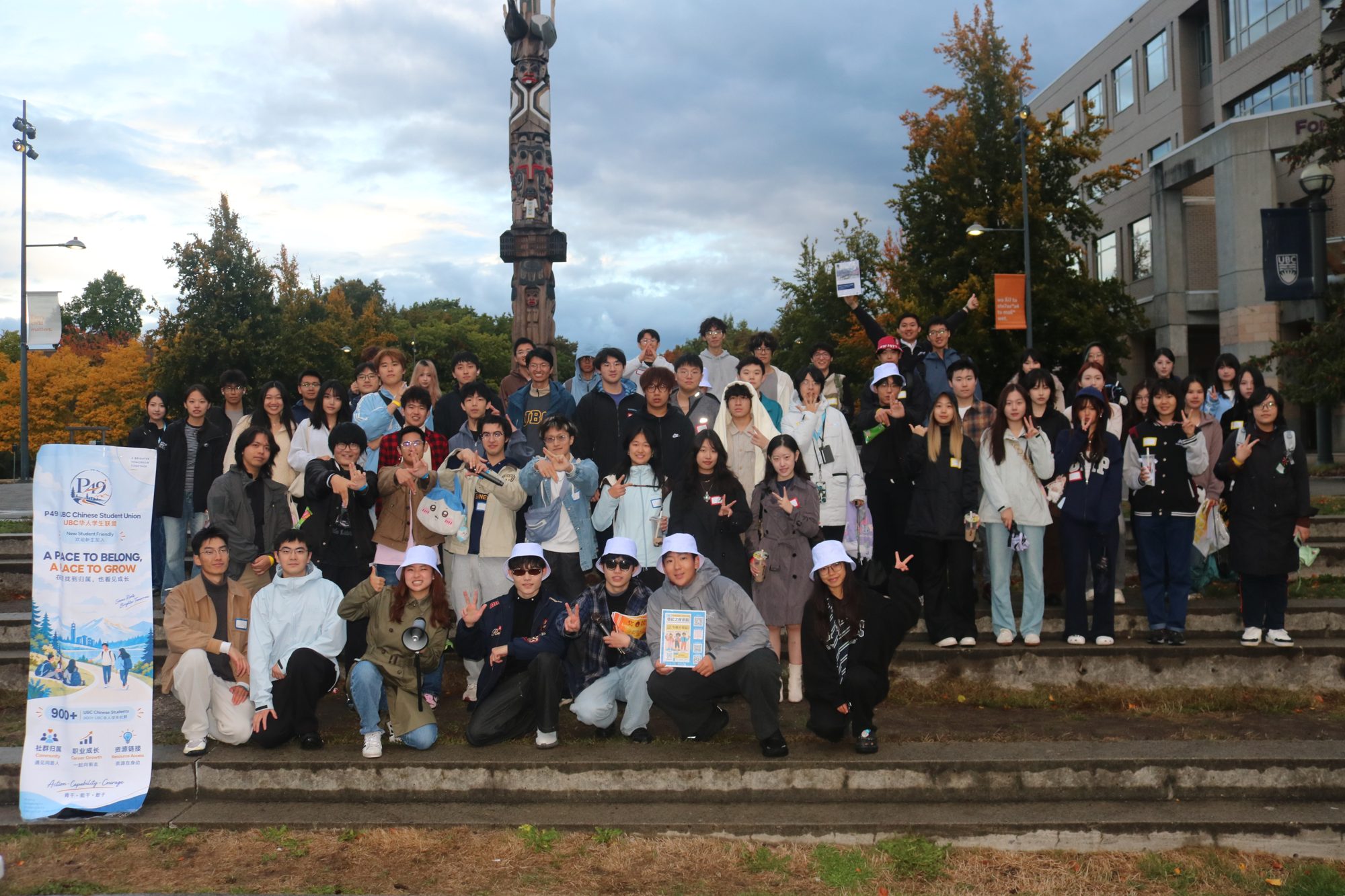 About 70 students on the steps by the totem pole at Come and Play, 25 September 2026